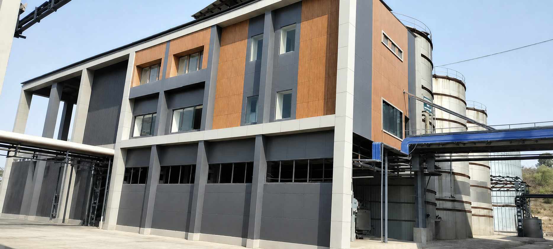 The grain distillery building at Bachai, with its storage tanks standing beside it.