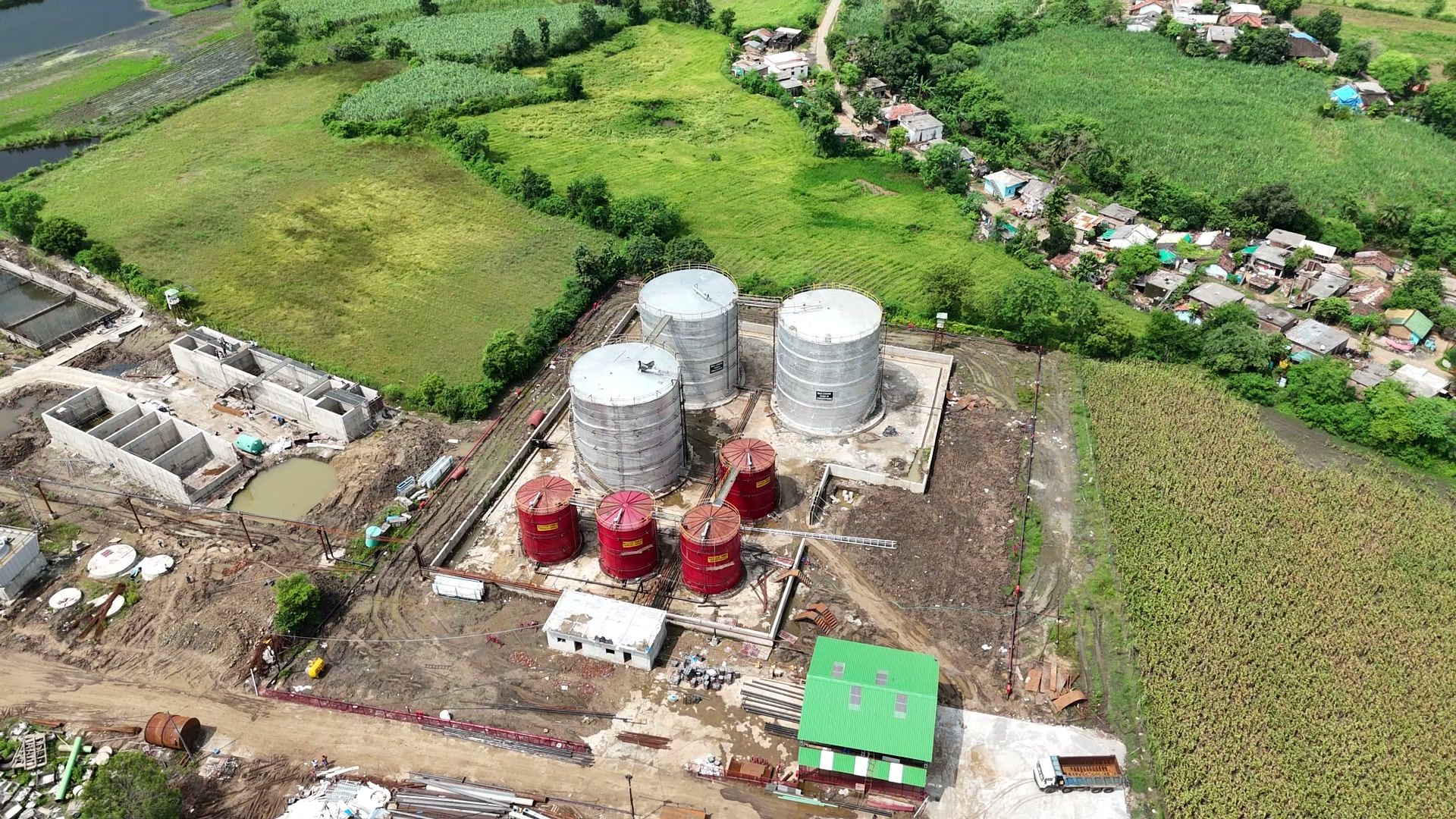 Aerial view over the fields and tanks at the site at Bachai