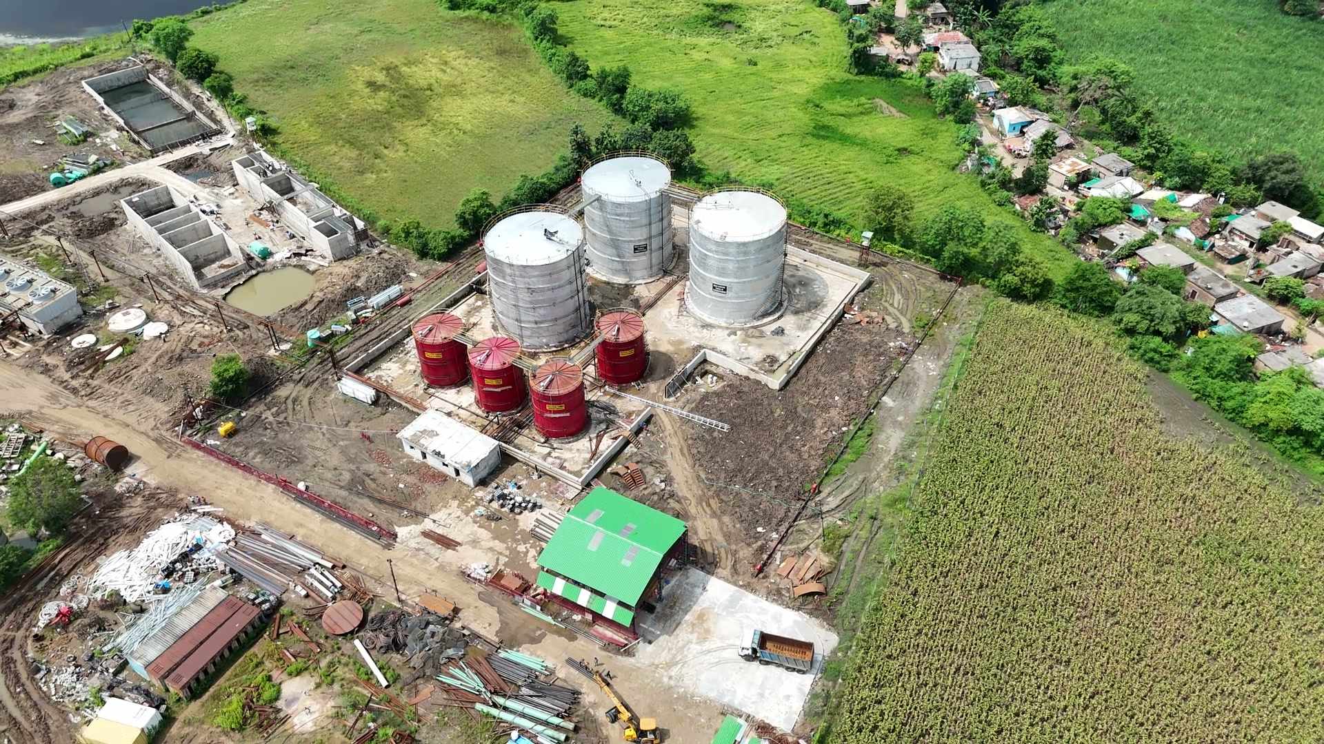 Aerial view of the complex at Bachai — the tanks, sheds and chimneys — with the fields of the command area beyond
